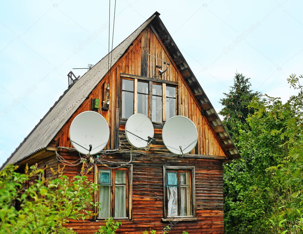Antennas on a wall of the old wooden house