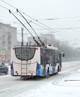 The trolleybus in snowfall clipart