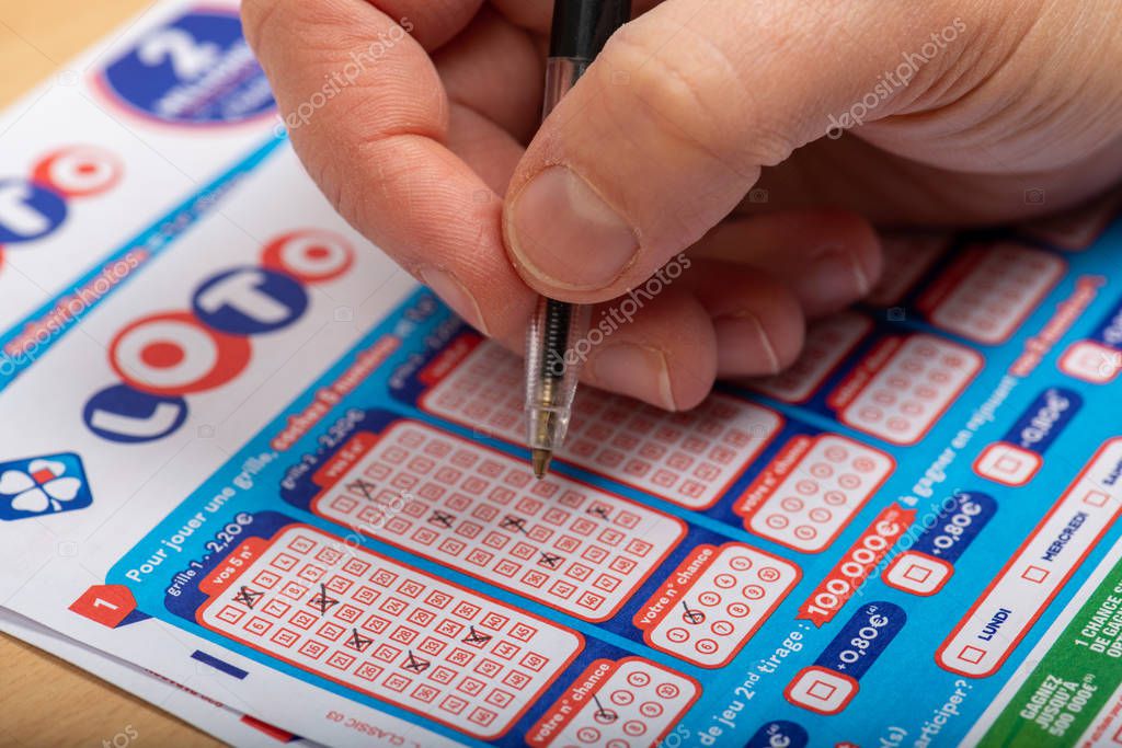 Paris, France -  November 21, 2019 : Closeup of aperson filling a lotto grid ,  from the society FDJ  (La francaise des jeux)