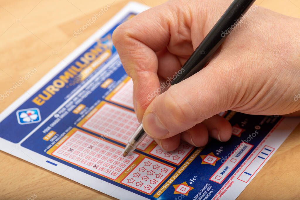 Paris, France -  November 21, 2019 : Closeup of aperson filling a lotto grid , Euromillions,   from the society FDJ  (La francaise des jeux)