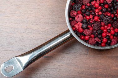 Metal bir tavada donmuş kırmızı çilek çeşitleri.