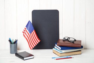 Kitap, defter, Not alanı ve ABD ahşap bir masa üzerinde bayrak. İngilizce dil öğrenme. Eğitim Amerika Birleşik Devletleri.