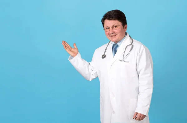 Male Doctor Showing Place Text Standing Blue Background Middle Aged — Stock Photo, Image