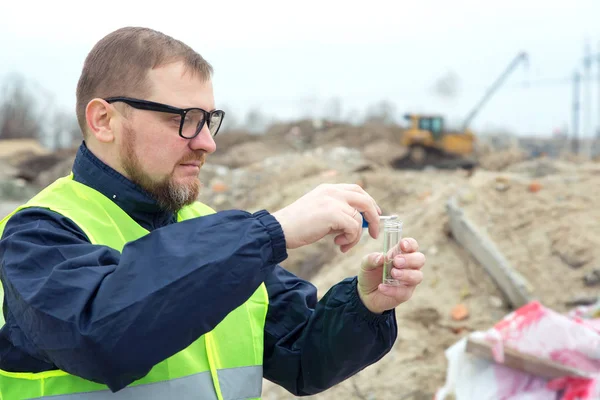 Ekolojist yetişkin adam. O inşaat artıkları ve toprak kirliliği kaldırılması doğan ekoloji sorunları çalışmaları.