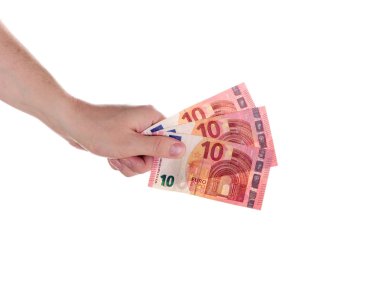 Euro para. Bir adamın elini üç banknotlar otuz Euro tutarında 10 Euro tutar. Beyaz bir arka plan üzerinde 10 avro.