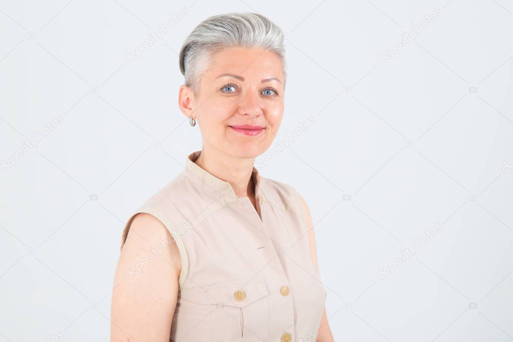 Close up female portrait. Beautiful mature woman on a light background.