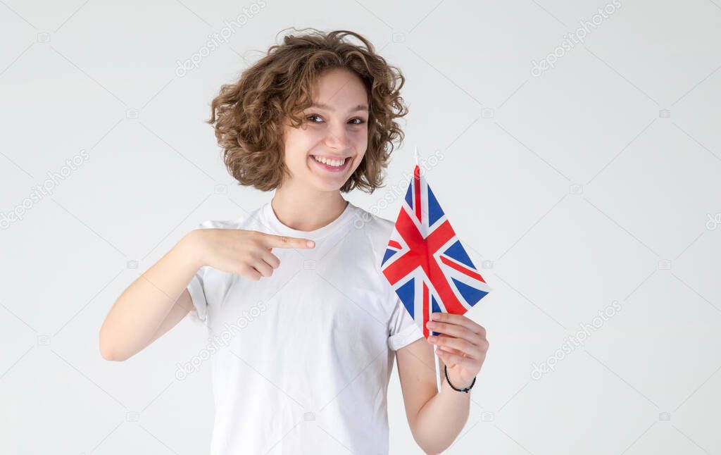 Young woman points to the flag of Great Britain, urging her to learn English.