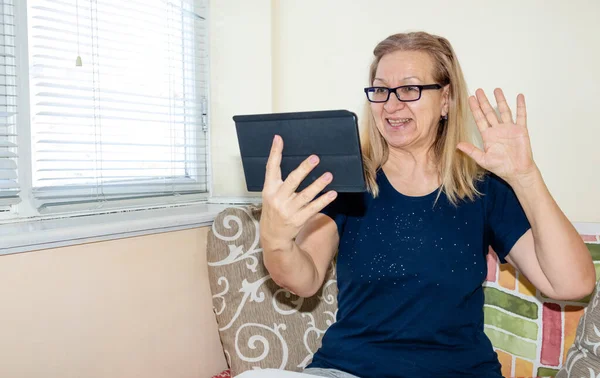 Mature Woman Communicates Online Telephony Using Digital Tablet While Sitting — Stock Photo, Image