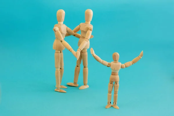 Concept Happy Family Child Group Three Wooden Men Blue Background — Stock Photo, Image