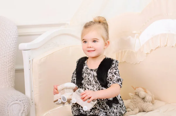 Little Cute Girl Plays Toy Knitted Train Sitting Bright Room — Stock Photo, Image