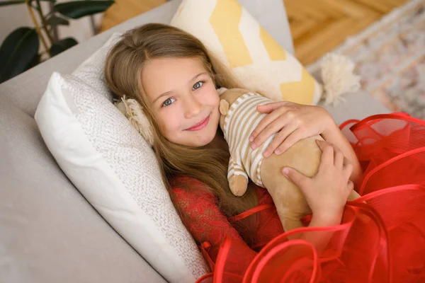 Girl Loving Affectionately Hugs Soft Teddy Bear Lying Sofa Pillow — Stock Photo, Image