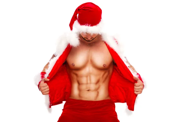 Seksi. Genç kaslı adam giyen Santa şapka onun göstermek