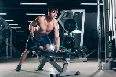 Spor, fitness, yaşam tarzı ve insanlar kavramı - kas spor salonunda dumbbells ile esneme
