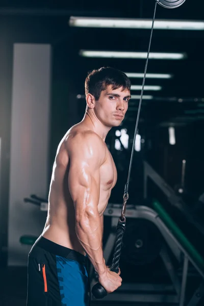 Muscular man working out in gym doing exercises at triceps, strong male naked torso abs — Stock Photo, Image