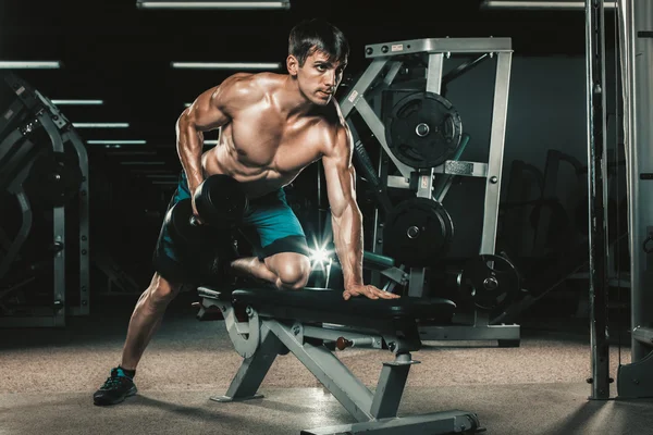 Deporte, fitness, estilo de vida y concepto de personas - flexionar los músculos con pesas en el gimnasio — Foto de Stock