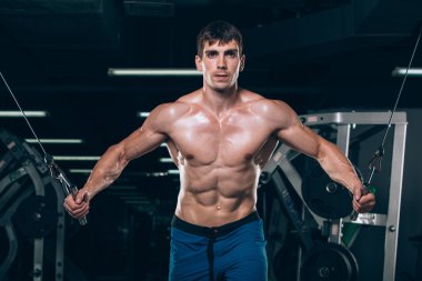 spor salonunda egzersiz kadar iterek yakışıklı vücut geliştirmeci çalışır