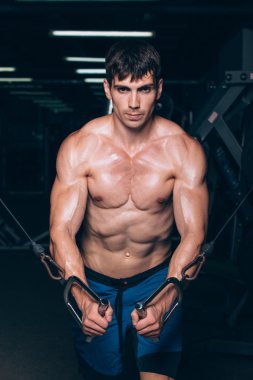 spor salonunda egzersiz kadar iterek yakışıklı vücut geliştirmeci çalışır