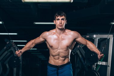 spor salonunda egzersiz kadar iterek yakışıklı vücut geliştirmeci çalışır