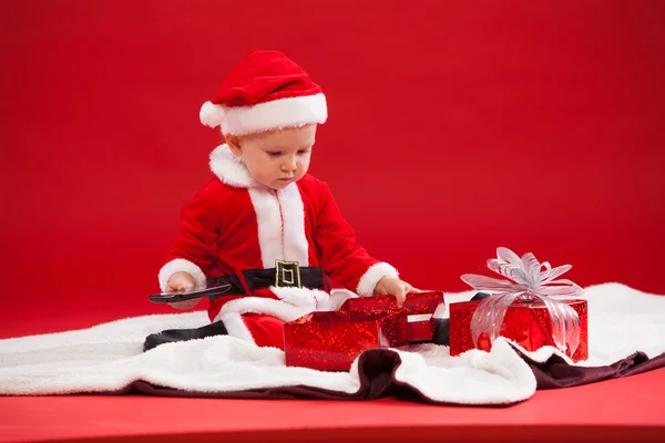 Красивий маленький дитина святкує Різдво. Нові років свята. з подарунком і телефон — стокове фото