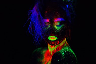 Beautiful extraterrestrial model woman with blue heair and green lips in neon light. It is portrait of beautiful model with fluorescent make-up, Art design of female posing in UV with colorful make up clipart