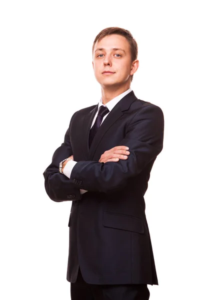 Jovem empresário bonito em terno preto está de pé em linha reta com braços cruzados, retrato de comprimento total isolado no fundo branco — Fotografia de Stock
