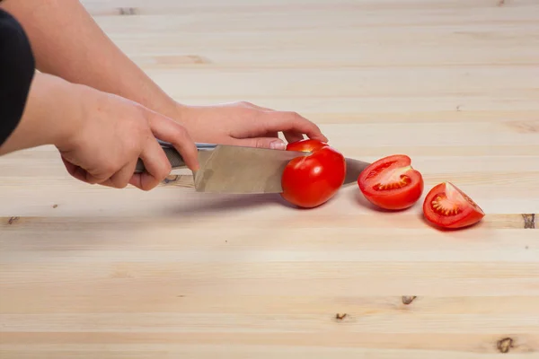 Cortar los tomates para los platos en la mesa. Hortalizas durante el proceso de cocción de los platos. Hortalizas para una alimentación y una dieta saludables — Foto de Stock