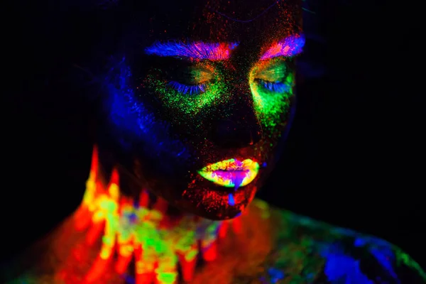 Bella donna modello extraterrestre in luce al neon. È ritratto di bel modello con trucco fluorescente, Progetto artistico di femmina che posa in UV con trucco colorato. Isolato su sfondo nero — Foto Stock