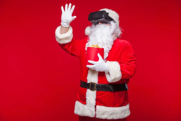 Santa Claus vistiendo gafas de realidad virtual y un ingenio cubo rojo — Foto de Stock