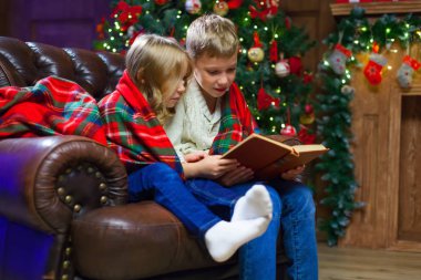 Bir ilgi okuma çocuk kitap karşı yatağa oturmuş