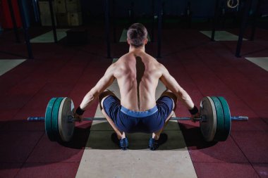 Kas fitness adam başını modern fitness merkezinde bir halter Deadlift için hazırlanıyor. Fonksiyonel eğitim. Egzersiz kapmak.