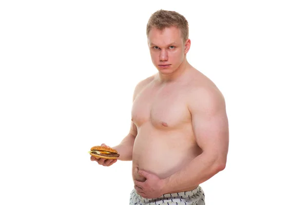 Λίπος άνθρωπος με Χάμπουργκερ απομονωμένη πρόχειρο γεύμα οδηγεί σε παχυσαρκία. Αναστάτωση από την ιδέα της δίαιτας. Προσπαθεί να πάει σε μια διατροφή. — Φωτογραφία Αρχείου