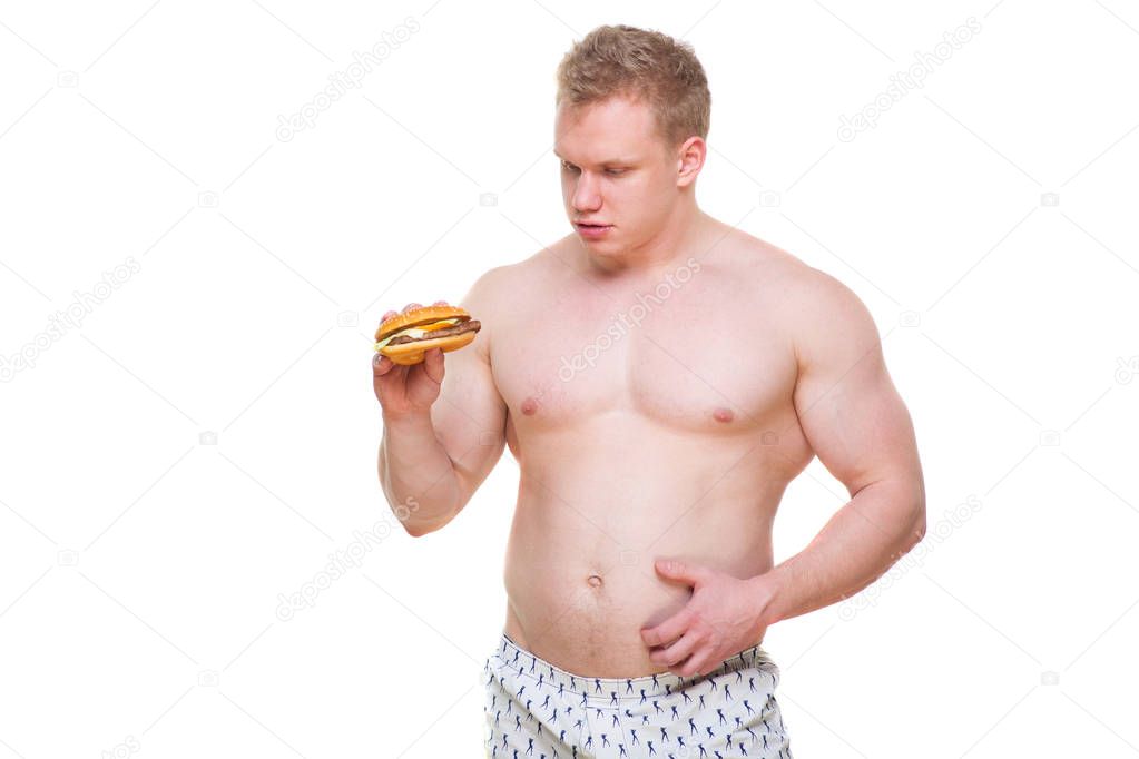 Fat man with hamburger isolated Junk meal leads to obesity. Disruption from diet concept. He is trying to go on a diet.
