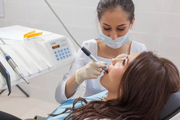 At the dentist. Female dentist in action