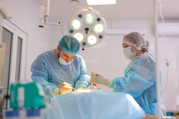 No hospital. O cirurgião opera na sala de operações. Médicos fazem todo o possível para tratar o paciente após um acidente . — Fotografia de Stock