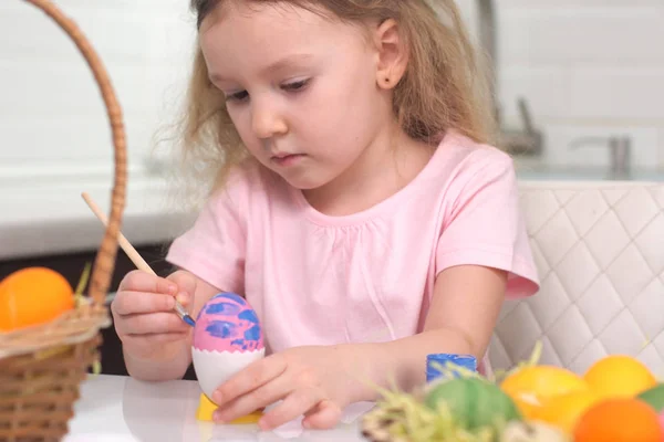 Gelukkig Pasen. Een klein meisje dat paaseieren schildert. Gelukkige familie kinderen bereiden zich voor op Pasen. schattig klein kind meisje dragen bunny oren op Pasen dag. — Stockfoto