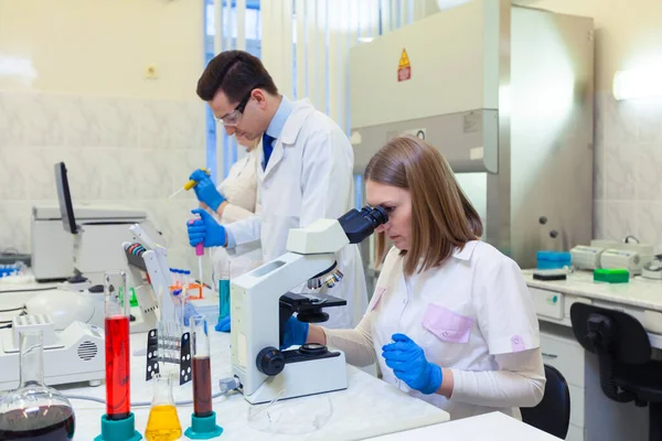 En grupp forskare bedriver forskning i ett vetenskapligt laboratorium med hjälp av avancerad teknik. — Stockfoto