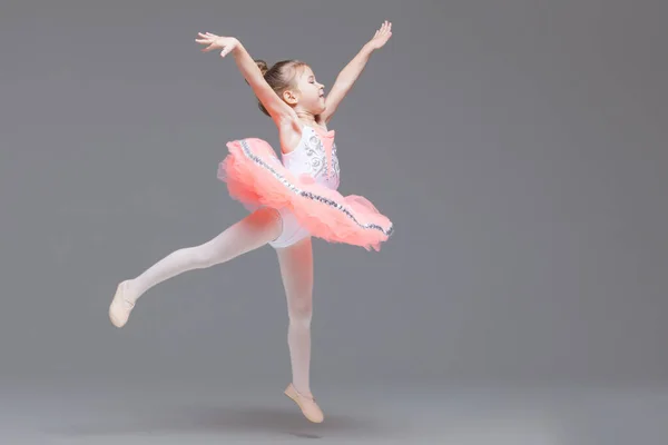 Cute adorable ballerina little girl in pink tutu dance practices ballet dancing — Stock Photo, Image