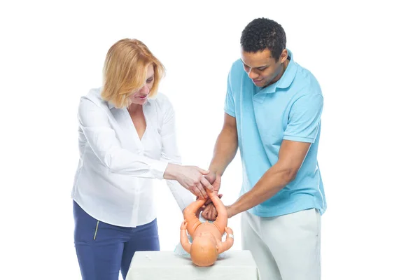 A young black man is being trained by an obstetrician to care for an unborn child. Learning on the layout of the child. — Stock Photo, Image