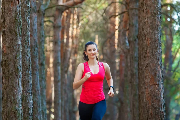Young woman runner training alone outdoors in the summer forest — Stock Photo, Image