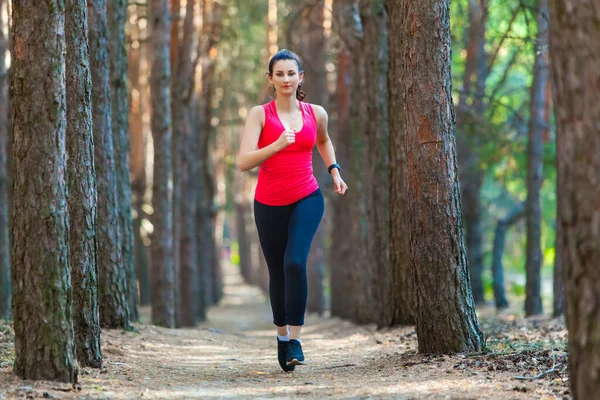Young woman runner training alone outdoors in the summer forest — Stock Photo, Image