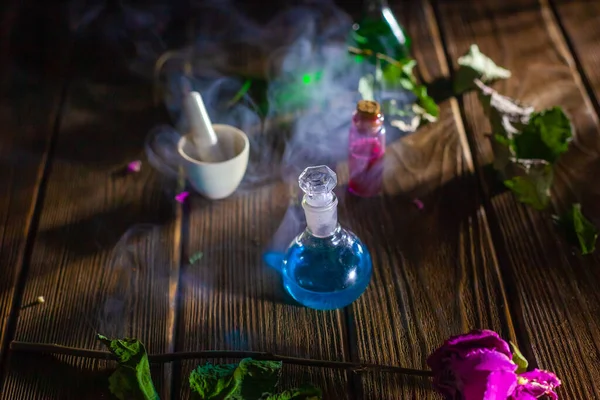 Witchcraft. Witch doctor desk table. Magic potion. ALternative medicine concept. Divination, love potion. Mysterious clouds of smoke.