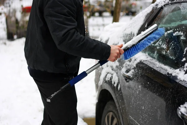 Clean the snow off the car.