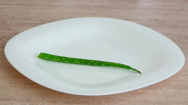 Hand putting two aloe vera leaves — Stock Video