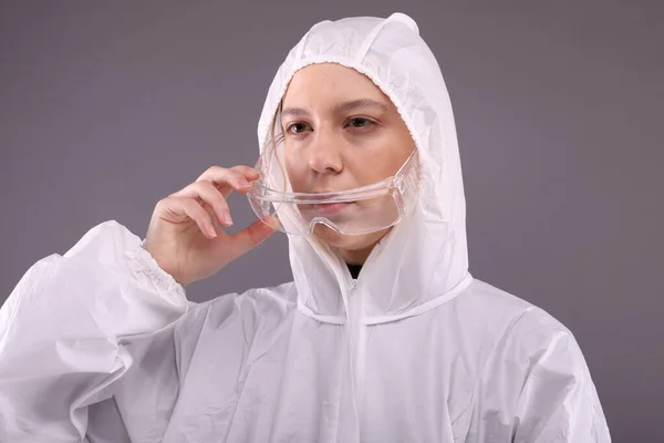 Woman in protective costume take off glasses — Stock Photo, Image