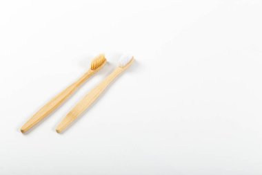 Toothbrushes made of eco materials, natural wood. On white background. clipart