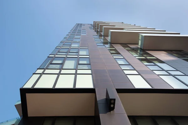 Close up dark brown futuristic architecture of an apartment building on a background of blue sky. 01.2020 Milan — Stock Photo, Image