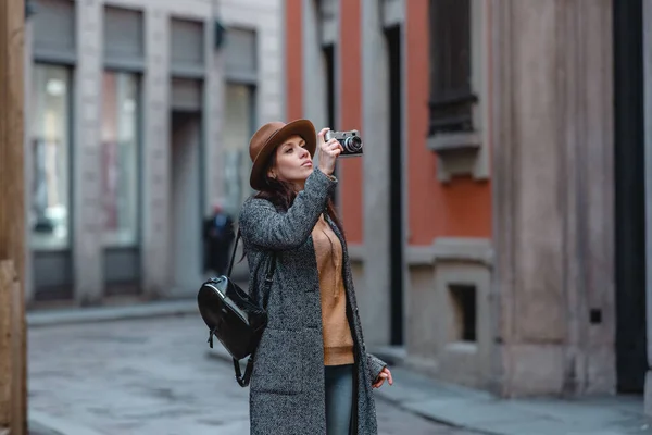 Девушка-туристка ходит и фотографирует здание . — стоковое фото