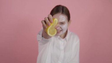 Yakın plan çekimde doğal meyve suyu sıkıyorum. Yüzünde krema olan kız..