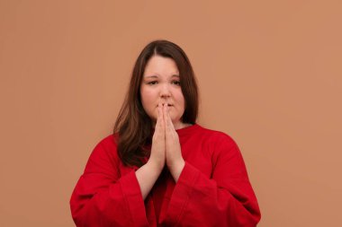 A young beautiful girl put her palms together and pray. clipart