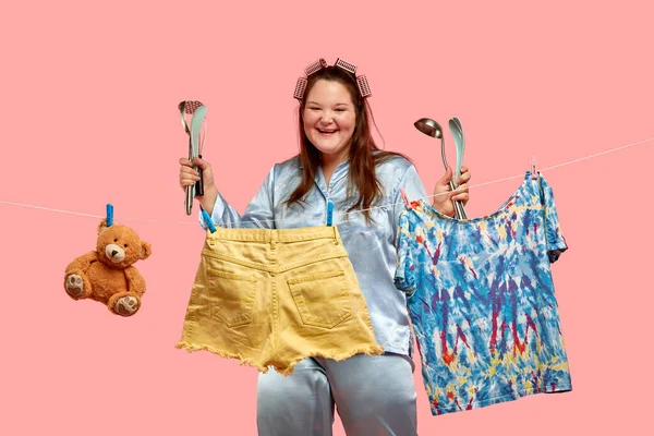 La chica sostiene utensilios de cocina. La lavandería está en primer plano . — Foto de Stock